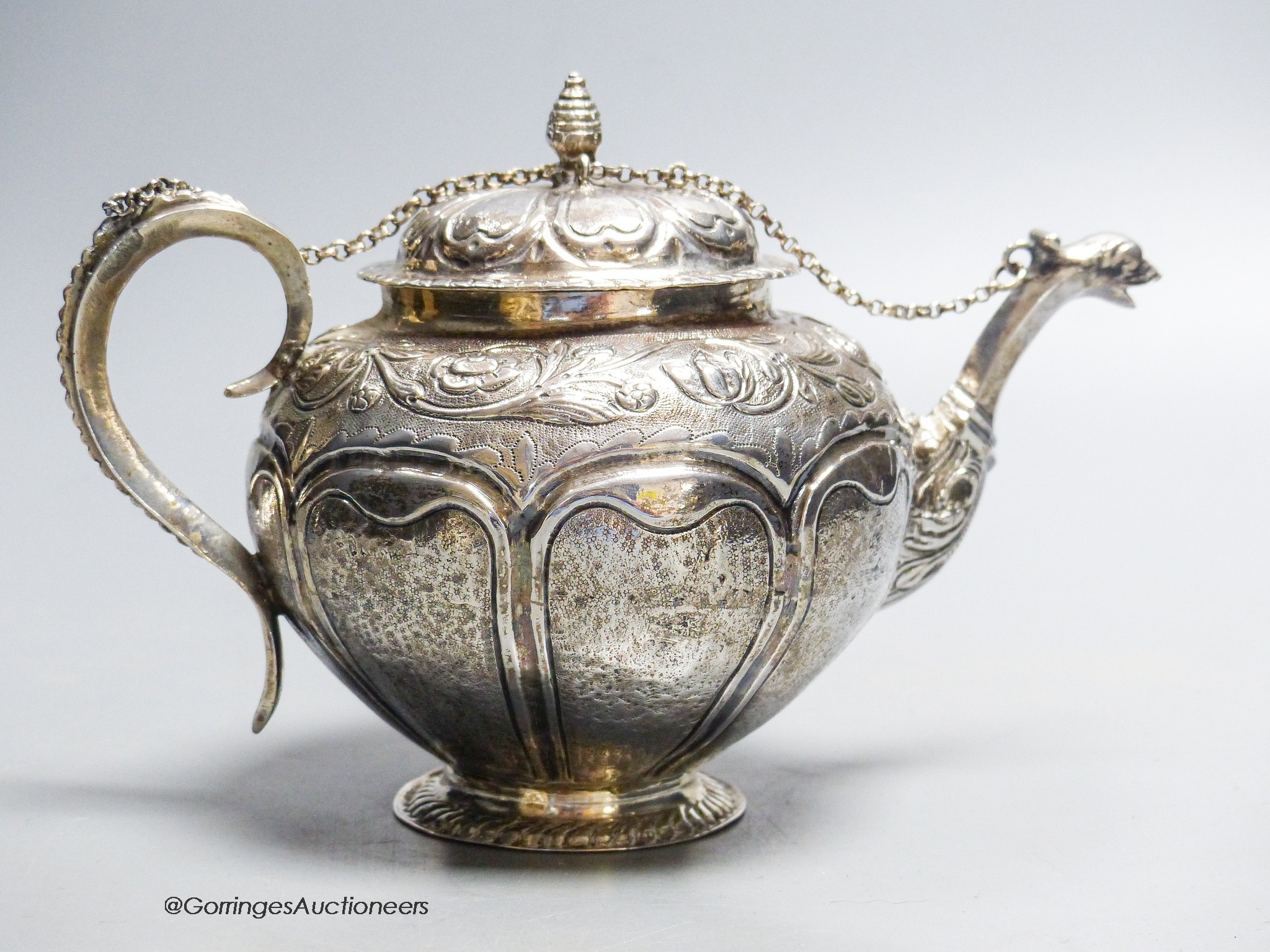 A late 18th/early 19th century Dutch? embossed white metal teapot, 13.5cm, gross 11.5oz